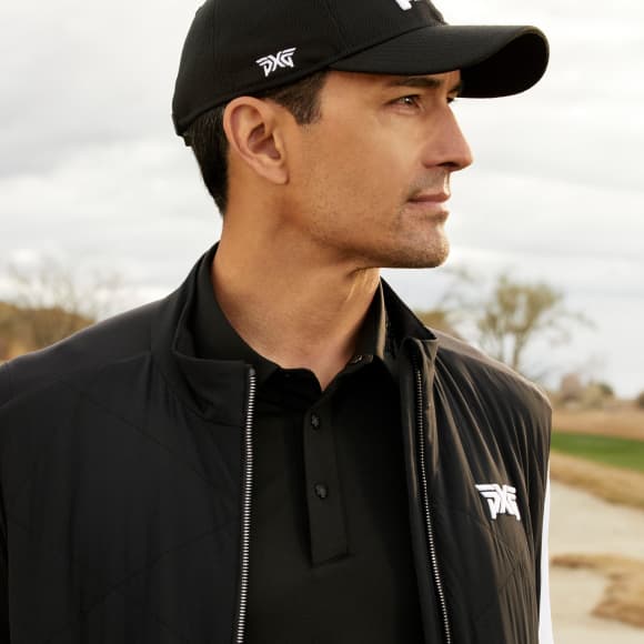 Man on a golf course wearing PXG apparel