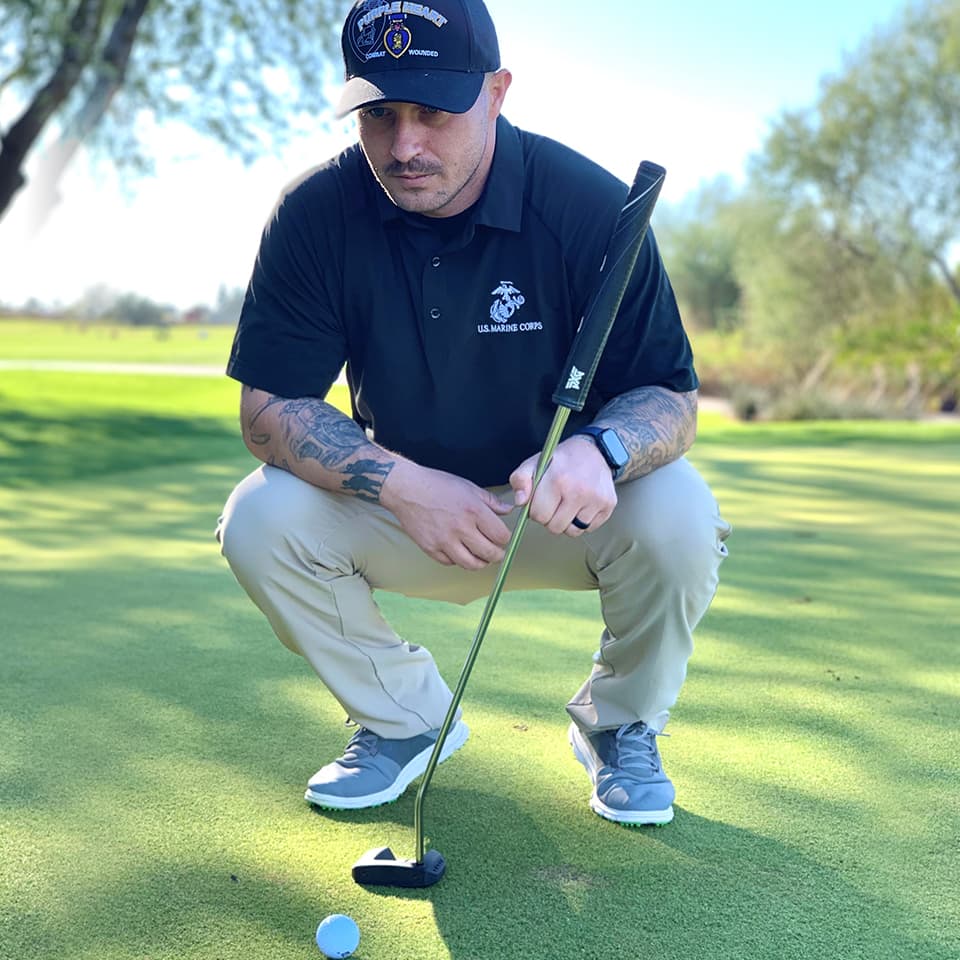 Man on golf course with club