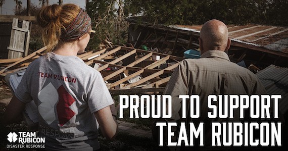 Team Rubicon members stand in front of wreckage