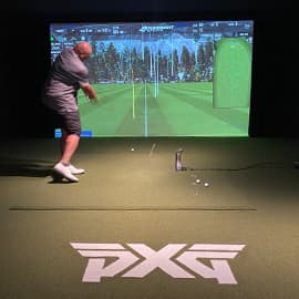 Charles Barkley swinging golf club at fitting