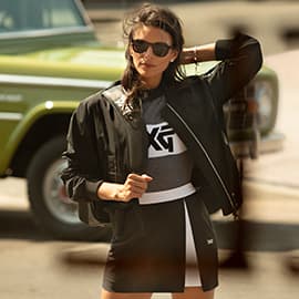 Woman stands in the street wearing PXG Apparel.