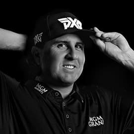Pat Perez headshot in PXG hat on a black background