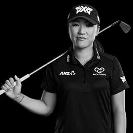 Lydia Ko posing with a golf club on a black background