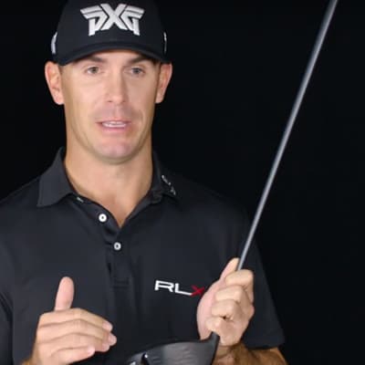PXG Pro holding a golf club